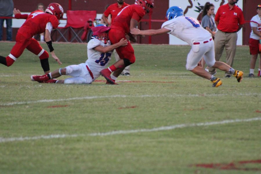 Mark Kilbourn and Justin Miller stop a Maysville runner in Friday night's win.