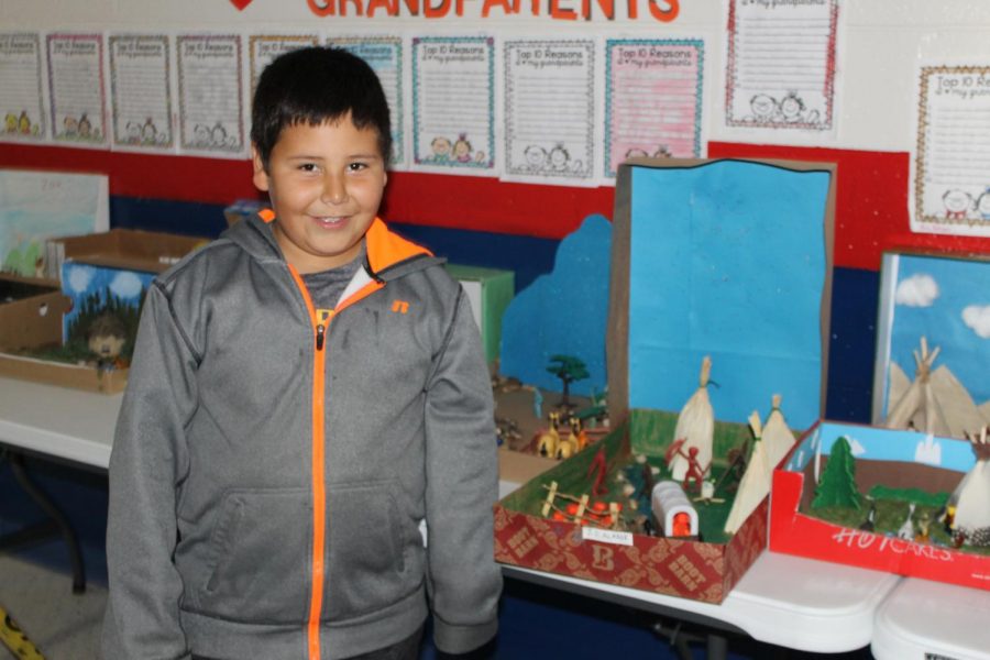 Junior Alvarez stands with his Native American diorama. 