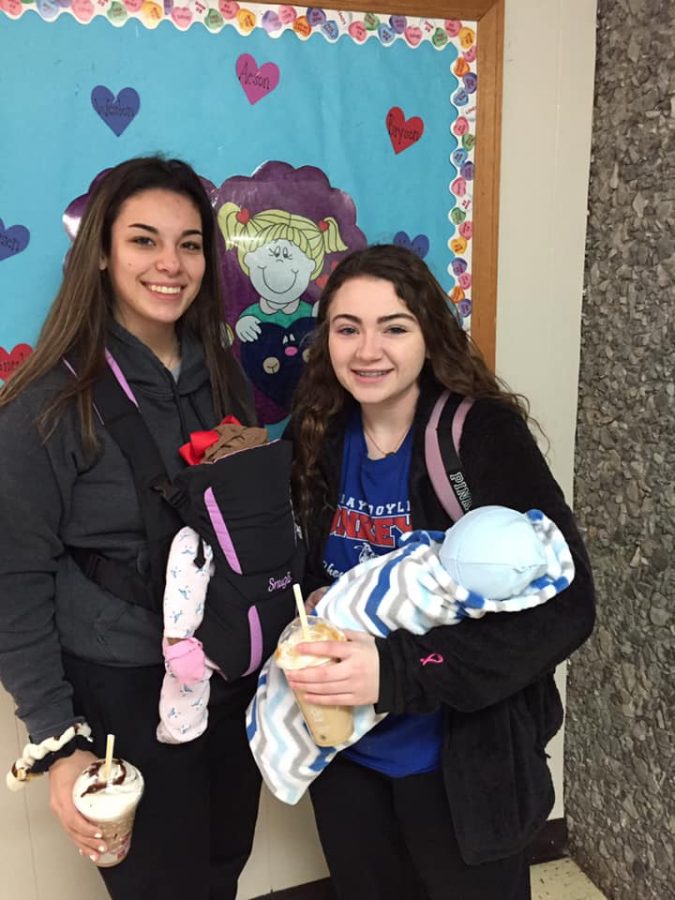 Ally Pineira and Rylie Pass stand holding their flour babies. 