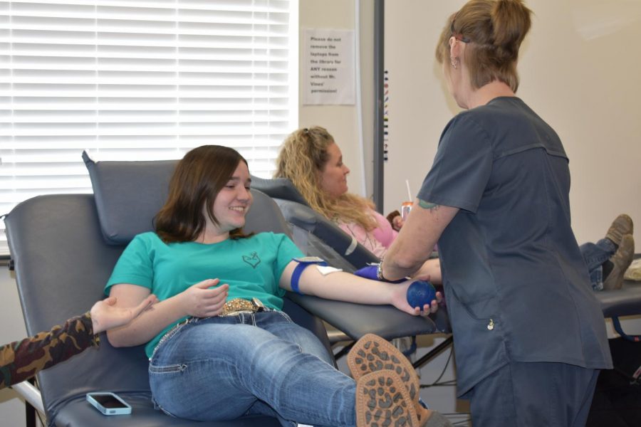 Hannah Cox gives blood during the fall blood drive. 