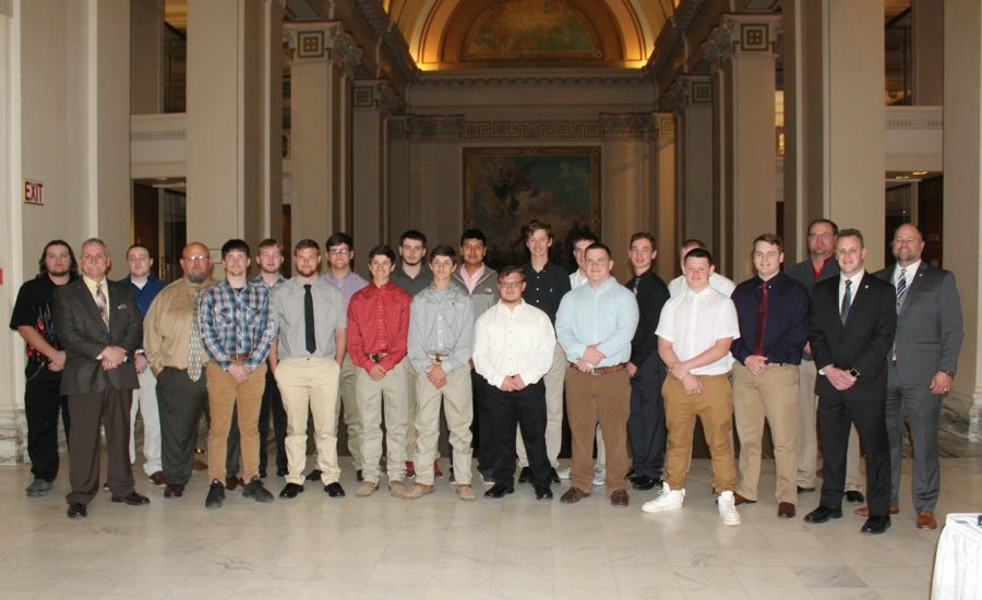 The Bray-Doyle football team stands with Rep. Brad Boles and Senator Paul Scott Tuesday, March 26 after being recognized for their Class B State Academic Championship. 