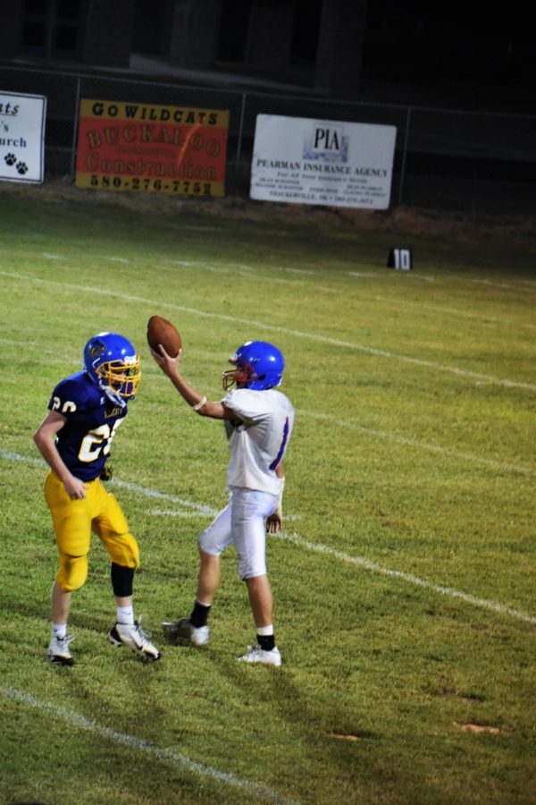 Cody Edwards celebrates holding the football after one of his five interceptions Friday night against Thackerville. 