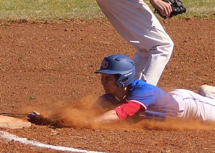 Jade Eldridge's photo of Weston Edwards, "Safe at Third" won first place in the Photo Journalism Category of the Annual Oklahoma Camera Club's photo contest. 